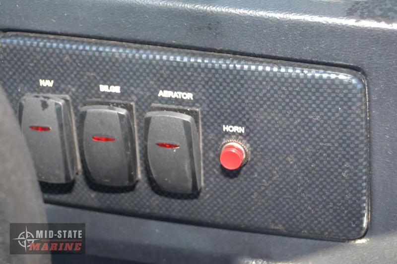 Slide: The Image of Control panel of 2024 Lowe Skorpion 16 boat with switches and horn button. - 17