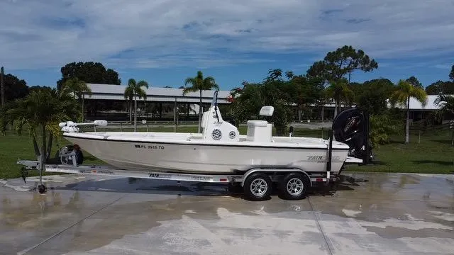 Slide: The Image of 2022 Pathfinder 2300 HPS boat on a trailer in a tropical setting. - 1