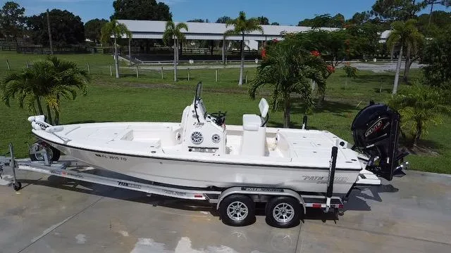 Slide: The Image of 2022 Pathfinder 2300 HPS boat on a trailer in a tropical setting. - 6