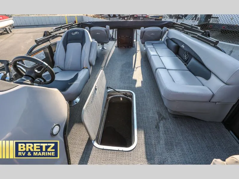 Slide: The Image of 2025 Aria Ultra-Lounge 22UC boat interior with gray seating and storage compartment. - 18