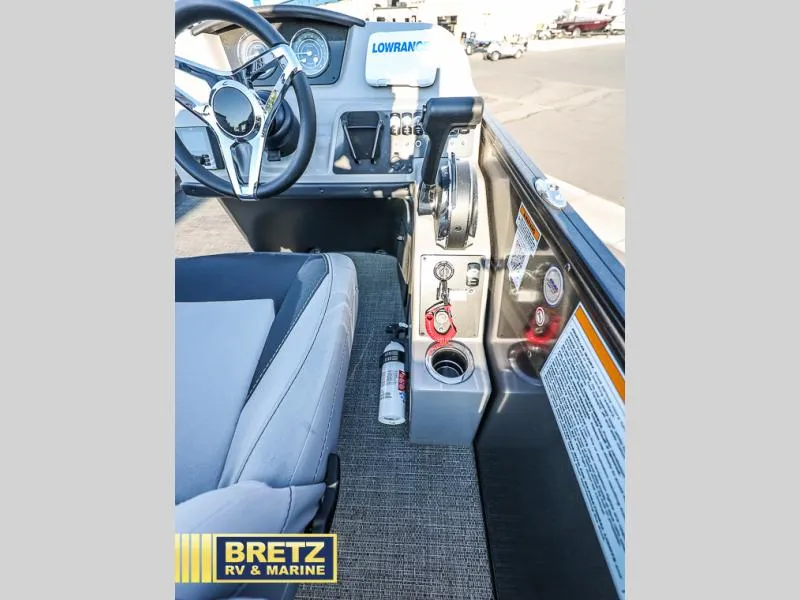 Slide: The Image of Aria Ultra-Lounge 22UC 2025 boat interior with steering wheel and controls. - 25