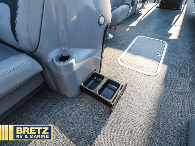 Slide: The Image of Aria Ultra-Lounge 22UC 2025 interior with cup holder and storage compartment. - 38