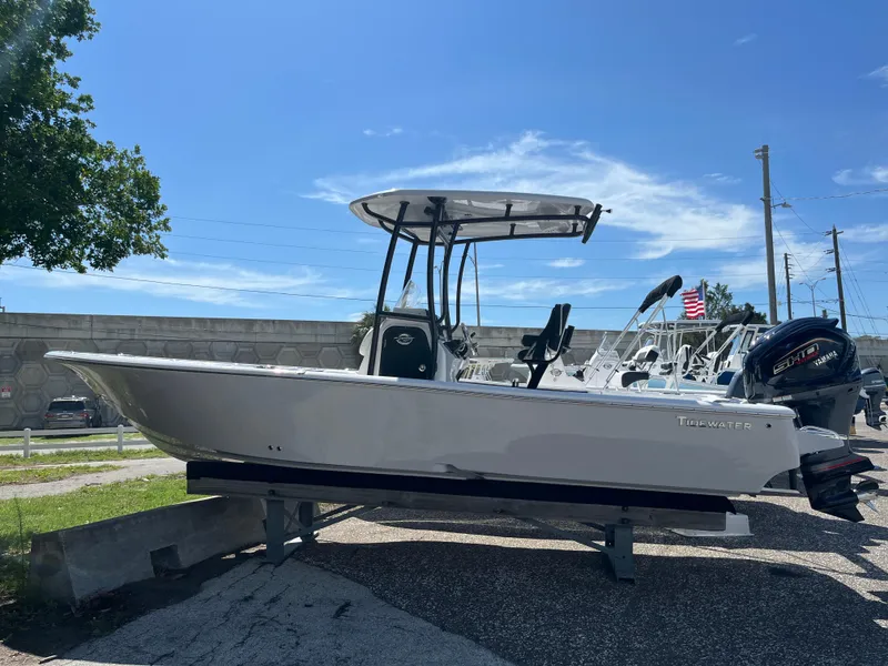 Slide: The Image of 2025 Tidewater 2300 Carolina Bay boat on display under clear sky. - 1