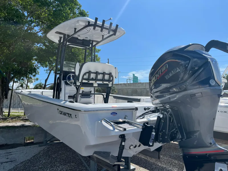 Slide: The Image of 2025 Tidewater 2300 Carolina Bay boat with Yamaha engine in outdoor setting. - 2