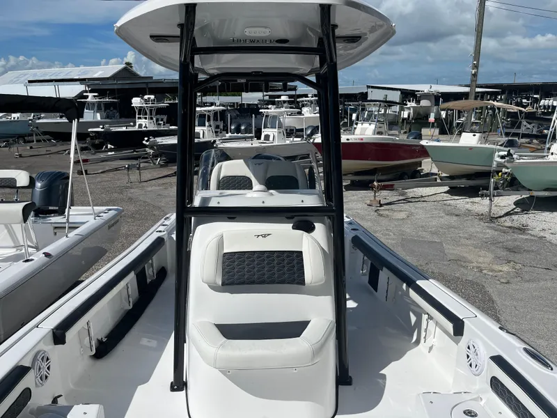 Slide: The Image of 2025 Tidewater 2300 Carolina Bay boat at a marina, showcasing seating and console. - 5