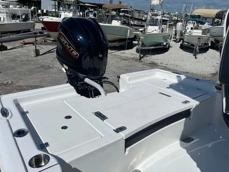 Slide: The Image of 2025 Tidewater 2300 Carolina Bay boat with outboard motor in marina. - 7