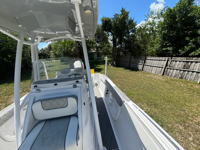 Slide: The Image of 2023 ALK2 Powerboats 25 CRX in a grassy yard, showcasing sleek design and seating. - 13