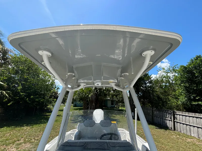 Slide: The Image of 2023 ALK2 Powerboats 25 CRX with T-top under clear blue sky. - 14