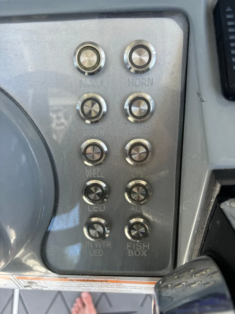 Slide: The Image of Control panel of 2023 ALK2 Powerboats 25 CRX with labeled buttons. - 16