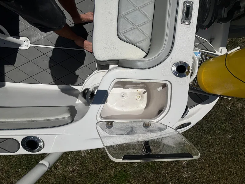 Slide: The Image of 2023 ALK2 Powerboats 25 CRX interior with open storage compartment and seating. - 19