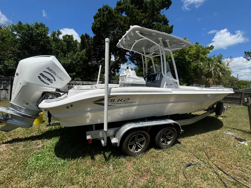 Slide: The Image of 2023 ALK2 Powerboats 25 CRX on trailer, parked on grass under a sunny sky. - 5