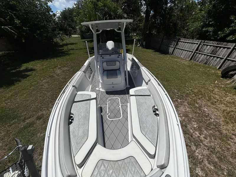 Slide: The Image of 2023 ALK2 Powerboats 25 CRX, sleek design, spacious deck, parked on grass. - 8
