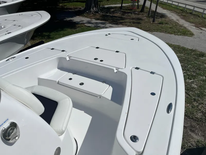 Slide: The Image of 2025 Tidewater 2110 Bay Max boat bow with storage compartments and seating. - 2