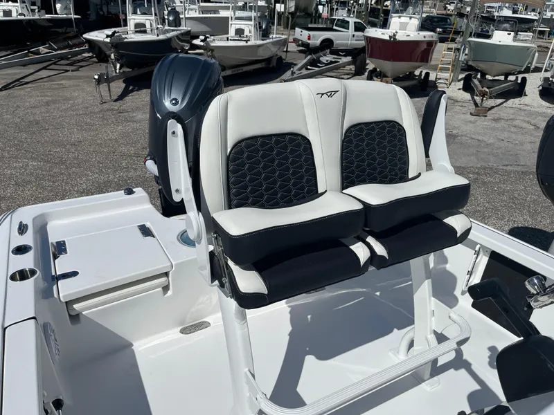 Slide: The Image of 2025 Tidewater 2110 Bay Max boat with dual seats and outboard motor. - 4