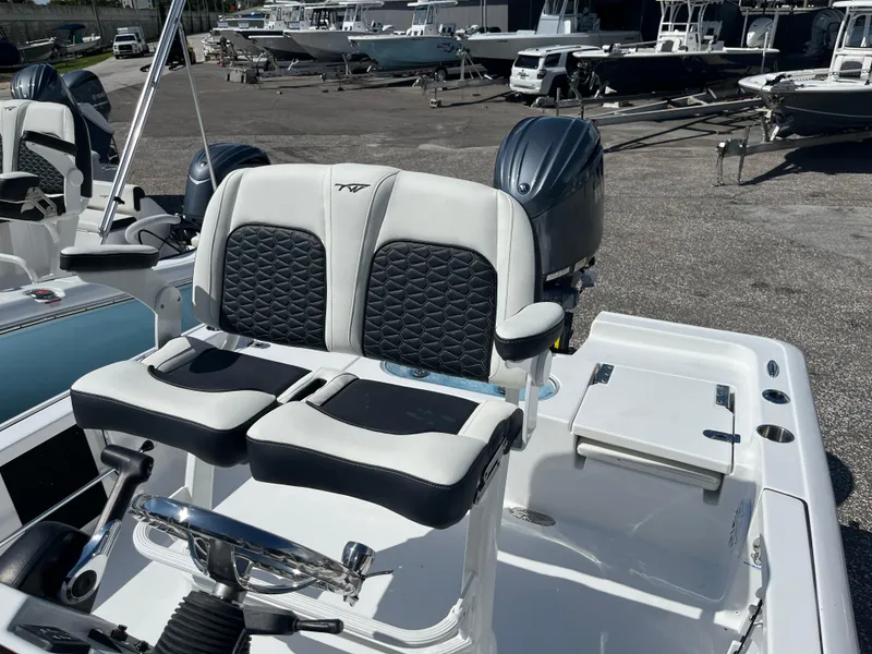 Slide: The Image of 2025 Tidewater 2110 Bay Max boat with dual seats and outboard motor. - 7