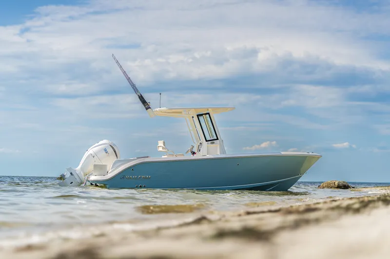 Slide: The Image of 2025 Sailfish 232 CC boat anchored near the shore on a sunny day. - 13
