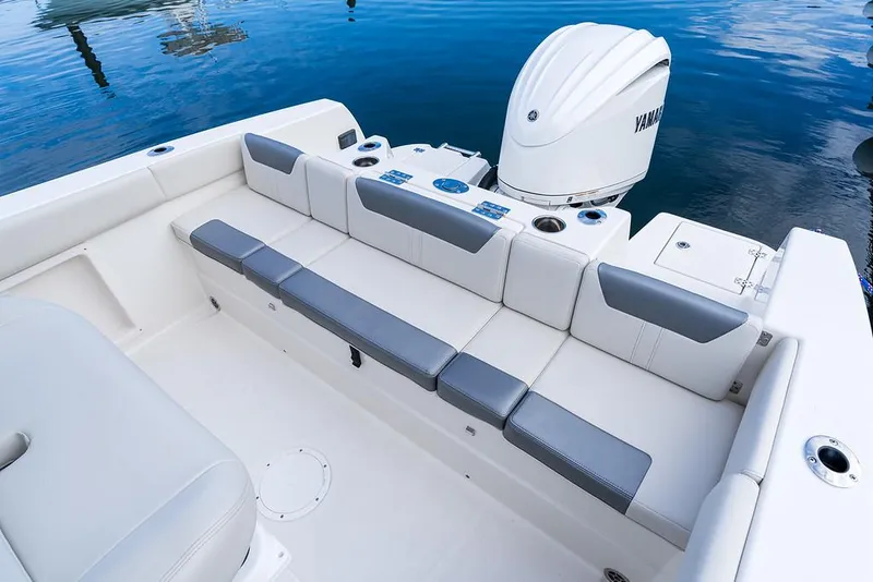 Slide: The Image of 2025 Sailfish 232 CC boat interior with cushioned seating and Yamaha outboard motor. - 9