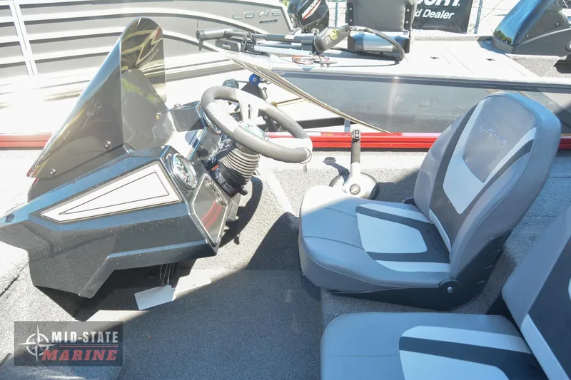 Slide: The Image of 2024 Lowe Stinger 195 Bass boat interior with steering wheel and seats. - 19