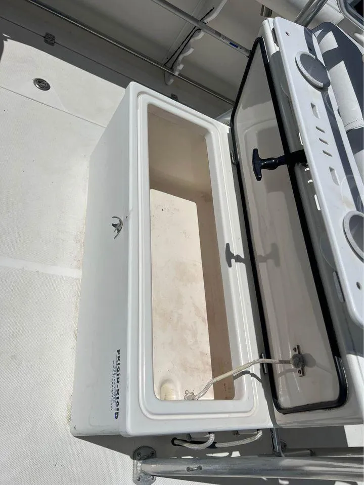 Slide: The Image of Open storage compartment on a 2007 Edgewater 268CC boat. - 13