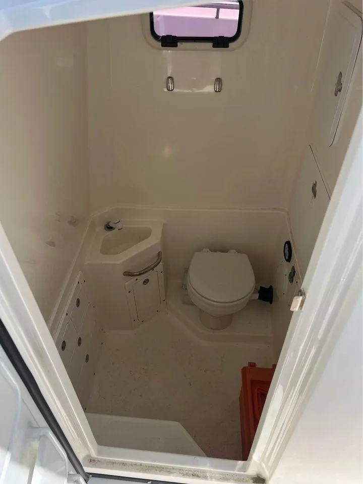 Slide: The Image of 2007 Edgewater 268CC boat interior bathroom with toilet and sink. - 14