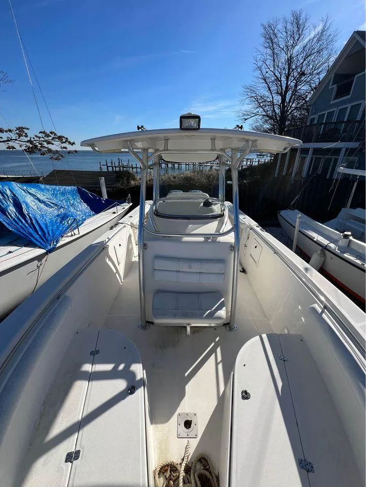 Slide: The Image of 2007 Edgewater 268CC center console boat docked near waterfront homes. - 4
