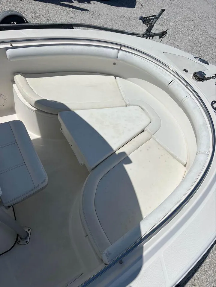 Slide: The Image of 2007 Edgewater 268CC boat interior with white cushioned seating. - 8