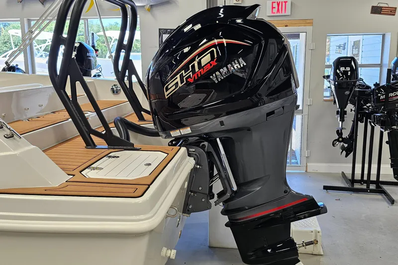 Slide: The Image of 2024 Starcraft SVX 210 OB DC boat with Yamaha outboard motor in showroom. - 3