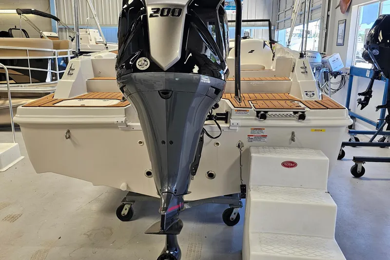 Slide: The Image of 2024 Starcraft SVX 210 OB DC boat with 200 HP outboard motor in showroom. - 5
