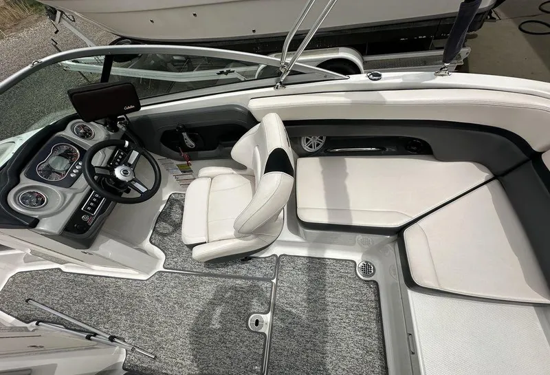 Slide: The Image of 2018 Chaparral 203 VR boat interior with white seating and modern dashboard. - 10