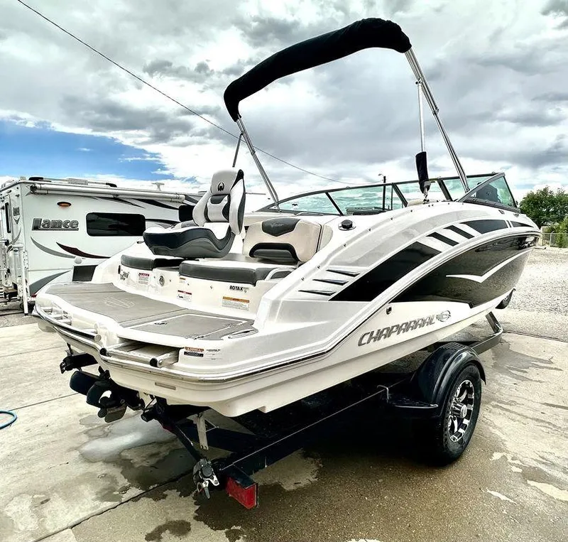 Slide: The Image of 2018 Chaparral 203 VR boat on trailer with bimini top, parked outdoors. - 4