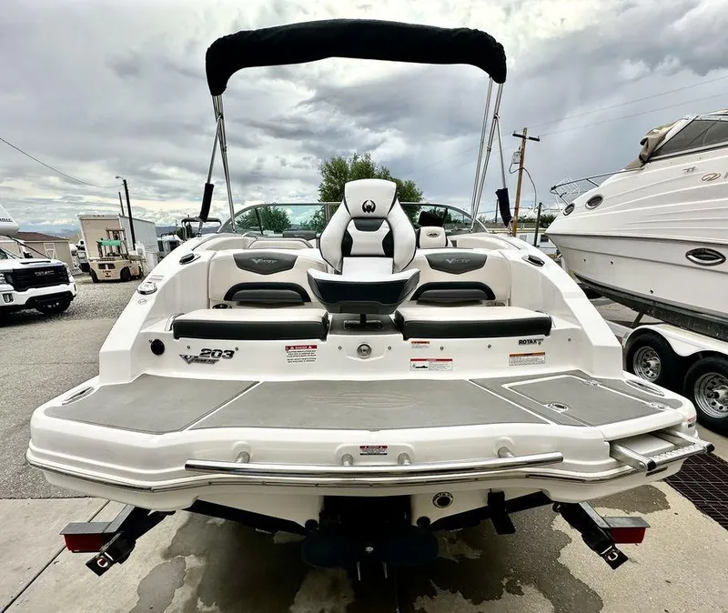 Slide: The Image of 2018 Chaparral 203 VR boat, rear view, docked, with seating and swim platform. - 6