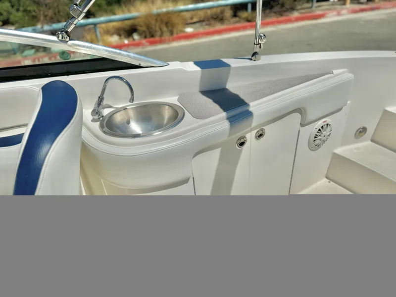 Slide: The Image of 2012 Sea Ray 260 SD boat interior with sink and seating area. - 16