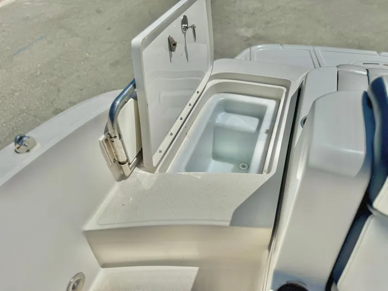 Slide: The Image of 2012 Sea Ray 260 SD boat cooler compartment with open lid. - 19