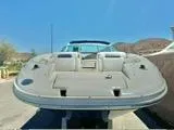 Slide: The Image of 2012 Sea Ray 260 SD boat, front view, parked outdoors under clear blue sky. - 2
