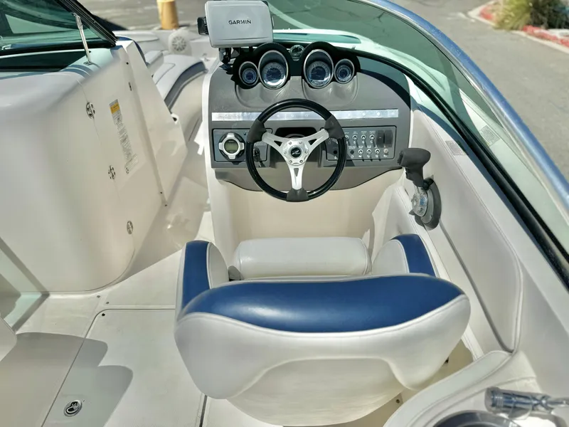 Slide: The Image of 2012 Sea Ray 260 SD boat cockpit with steering wheel and Garmin navigation system. - 24
