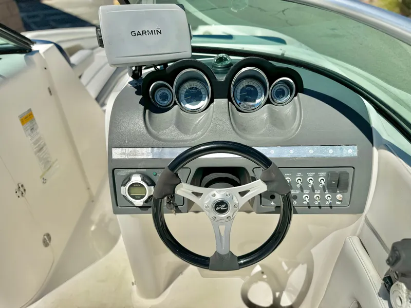 Slide: The Image of 2012 Sea Ray 260 SD dashboard with Garmin GPS and steering wheel. - 25
