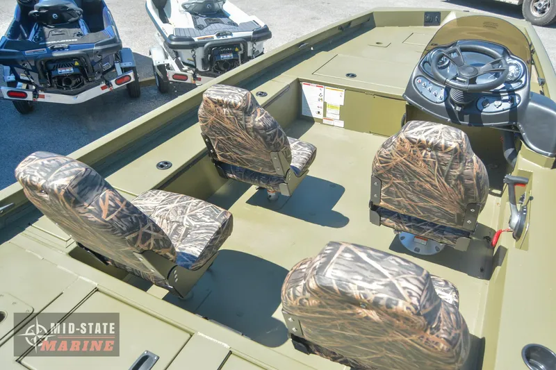 Slide: The Image of 2024 Lowe Outlet 20 boat interior with camo seats and steering console. - 14