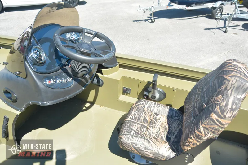 Slide: The Image of 2024 Lowe Outlet 20 boat interior with steering wheel and camo seat. - 18