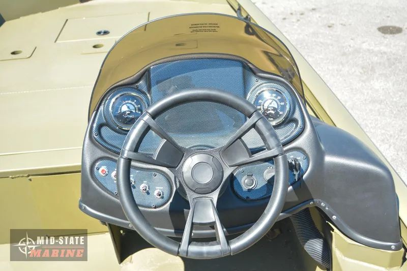 Slide: The Image of 2024 Lowe Outlet 20 boat dashboard and steering wheel. - 20