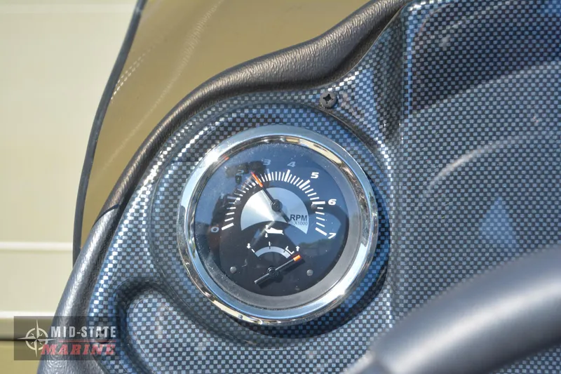 Slide: The Image of Close-up of 2024 Lowe Outlet 20 boat tachometer and fuel gauge. - 21