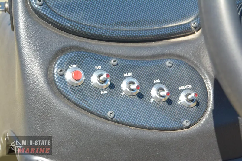 Slide: The Image of Control panel of a 2024 Lowe Outlet 20 boat with various switches. - 23