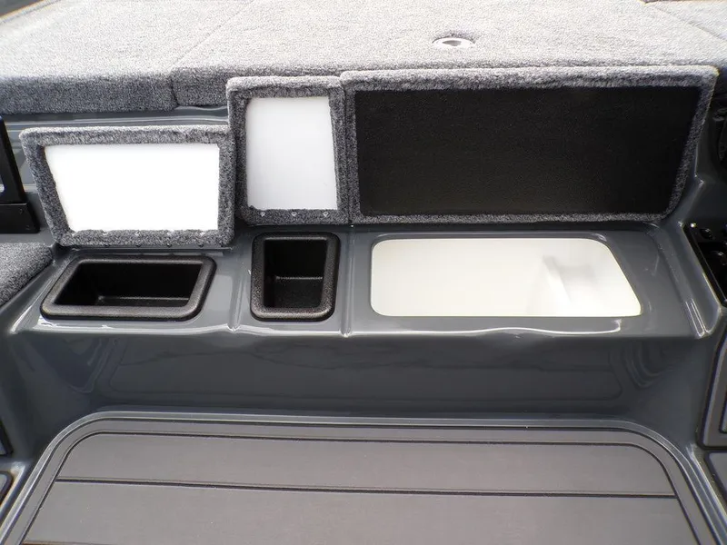 Slide: The Image of Phoenix 920 Elite 2025 boat storage compartments with carpeted lids and sleek design. - 11