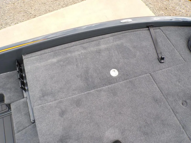 Slide: The Image of 2025 Phoenix 920 Elite boat deck with gray carpet and storage compartment. - 13