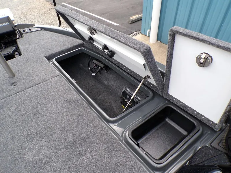 Slide: The Image of Phoenix 920 Elite 2025 boat storage compartments with open lids, showcasing interior space. - 14