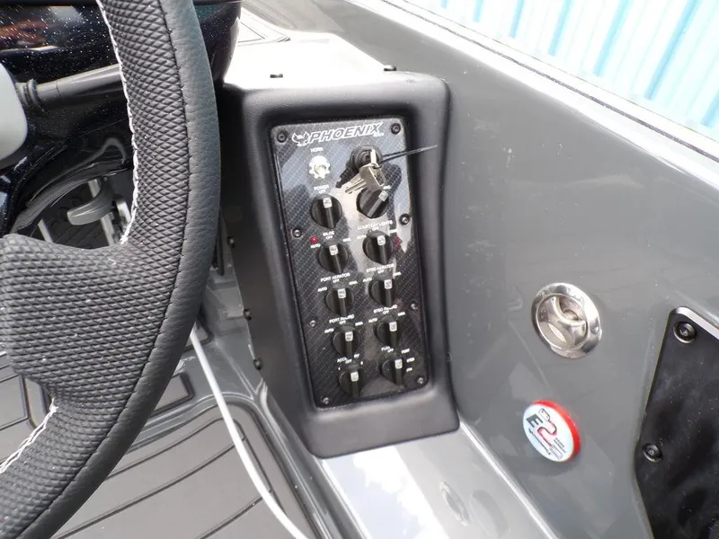 Slide: The Image of Control panel of 2025 Phoenix 920 Elite boat with steering wheel. - 25
