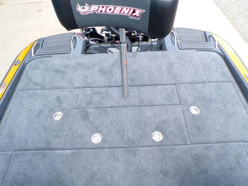 Slide: The Image of 2025 Phoenix 920 Elite boat deck with gray carpet and logo. - 29