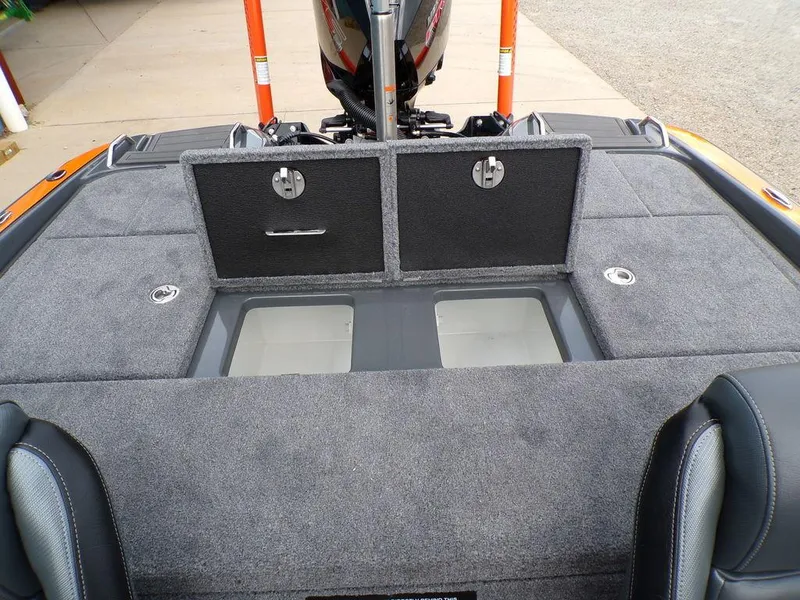 Slide: The Image of Phoenix 920 Elite 2025 boat interior with storage compartments and carpeted deck. - 30