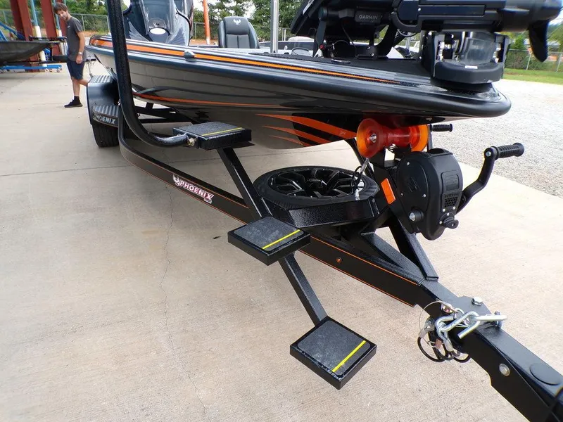 Slide: The Image of 2025 Phoenix 920 Elite boat trailer with steps and winch, parked on concrete. - 32