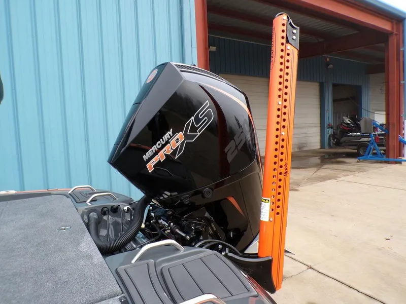 Slide: The Image of Phoenix 920 Elite 2025 boat with Mercury Pro XS engine, docked near blue building. - 36