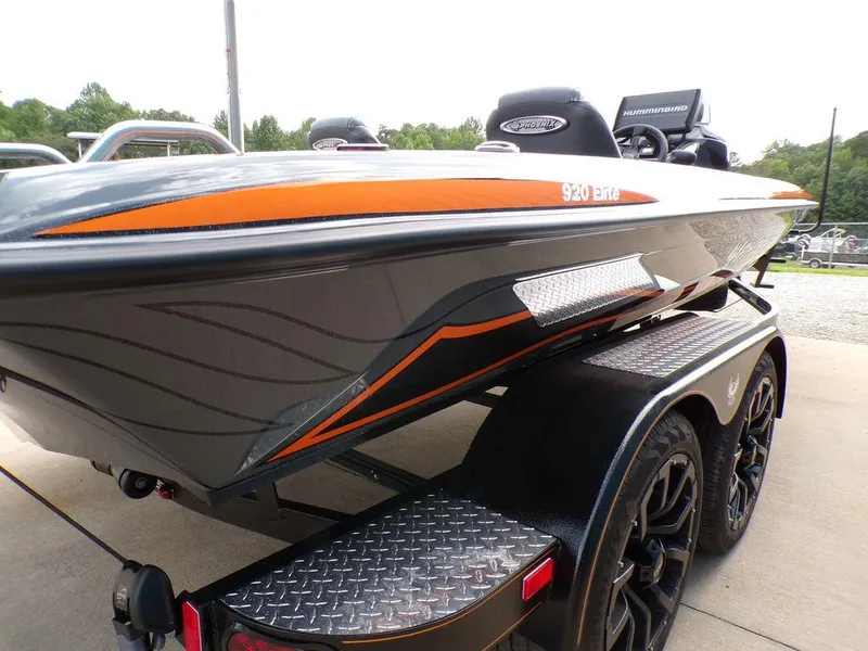 Slide: The Image of 2025 Phoenix 920 Elite boat with sleek design and orange accents on a trailer. - 6